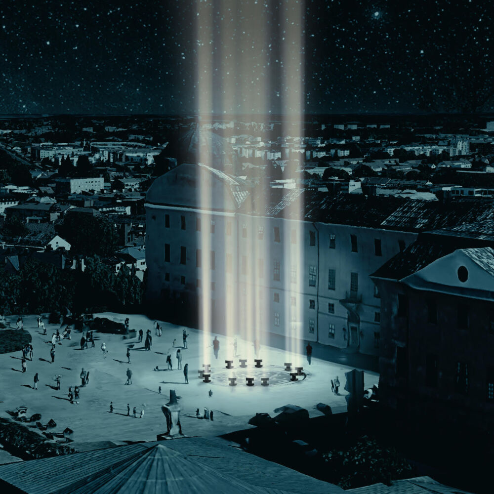 Stad i mörker med ljuspelare över